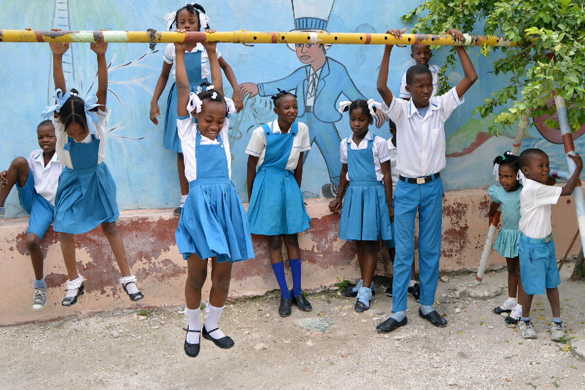 A group of young Haitian students playing at L'Ecole Dinaus Mixed
