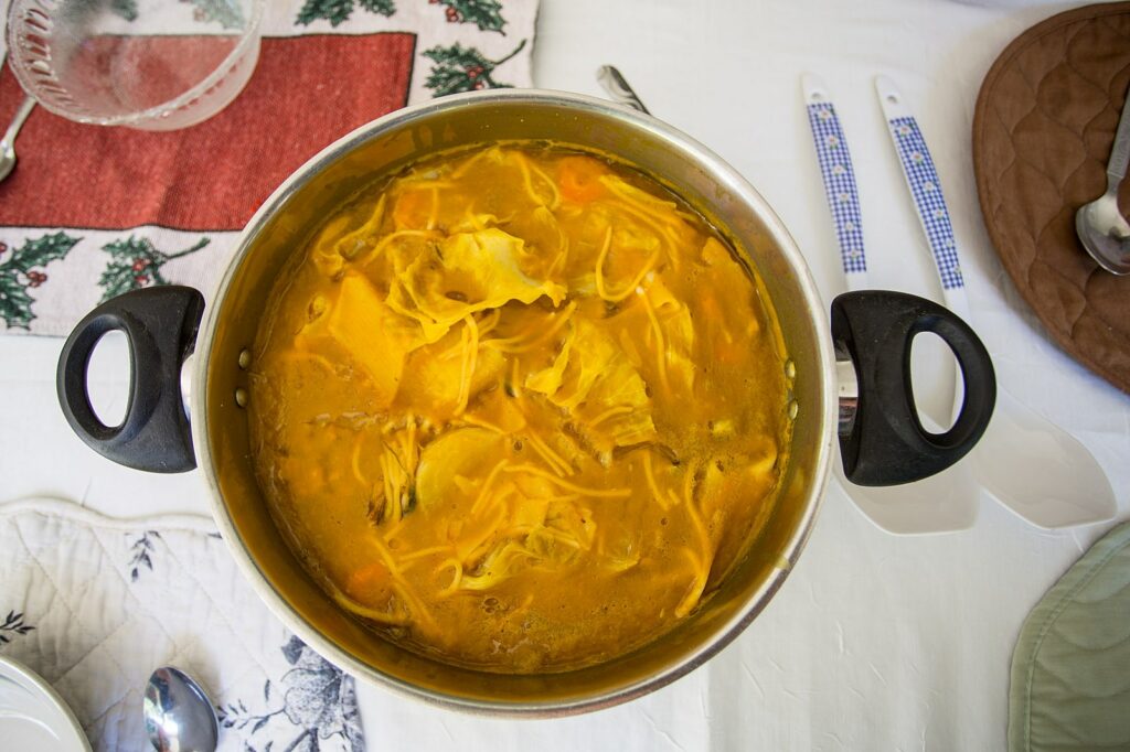 A large pot of soup joumou, a hearty pumpkin soup from Haiti